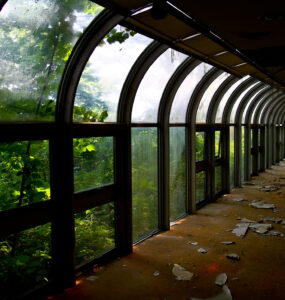 Explore abandoned Yamanakako Lake resort, with weathered walkways and lush green surroundings.