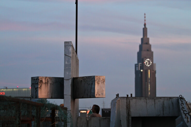 Urban Symphony: Modern skyscraper against industrial backdrop in Shinjuku at sunset.