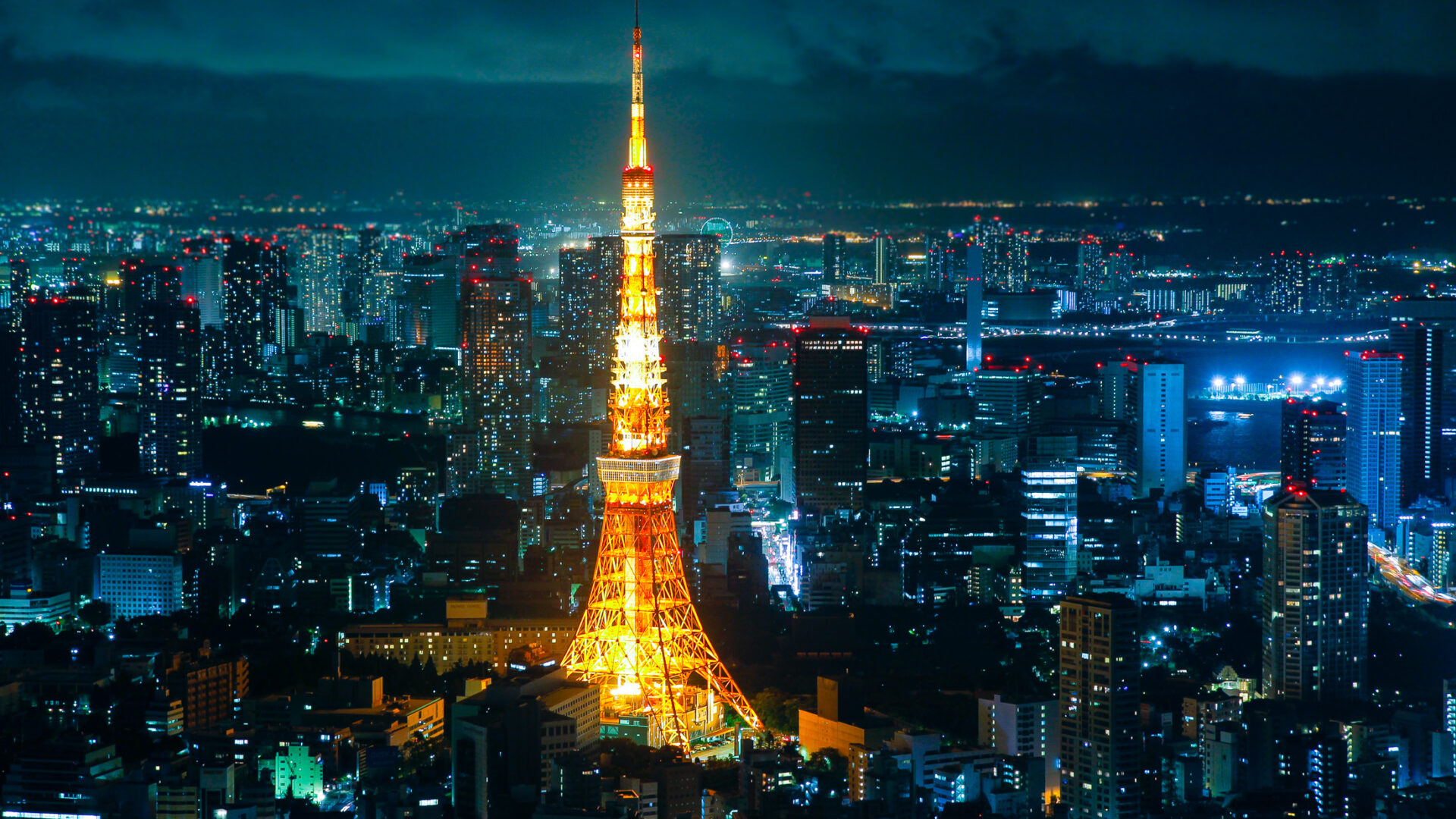 Tokyo Tower at night: iconic landmark in Japans capital, illuminated in golden light.