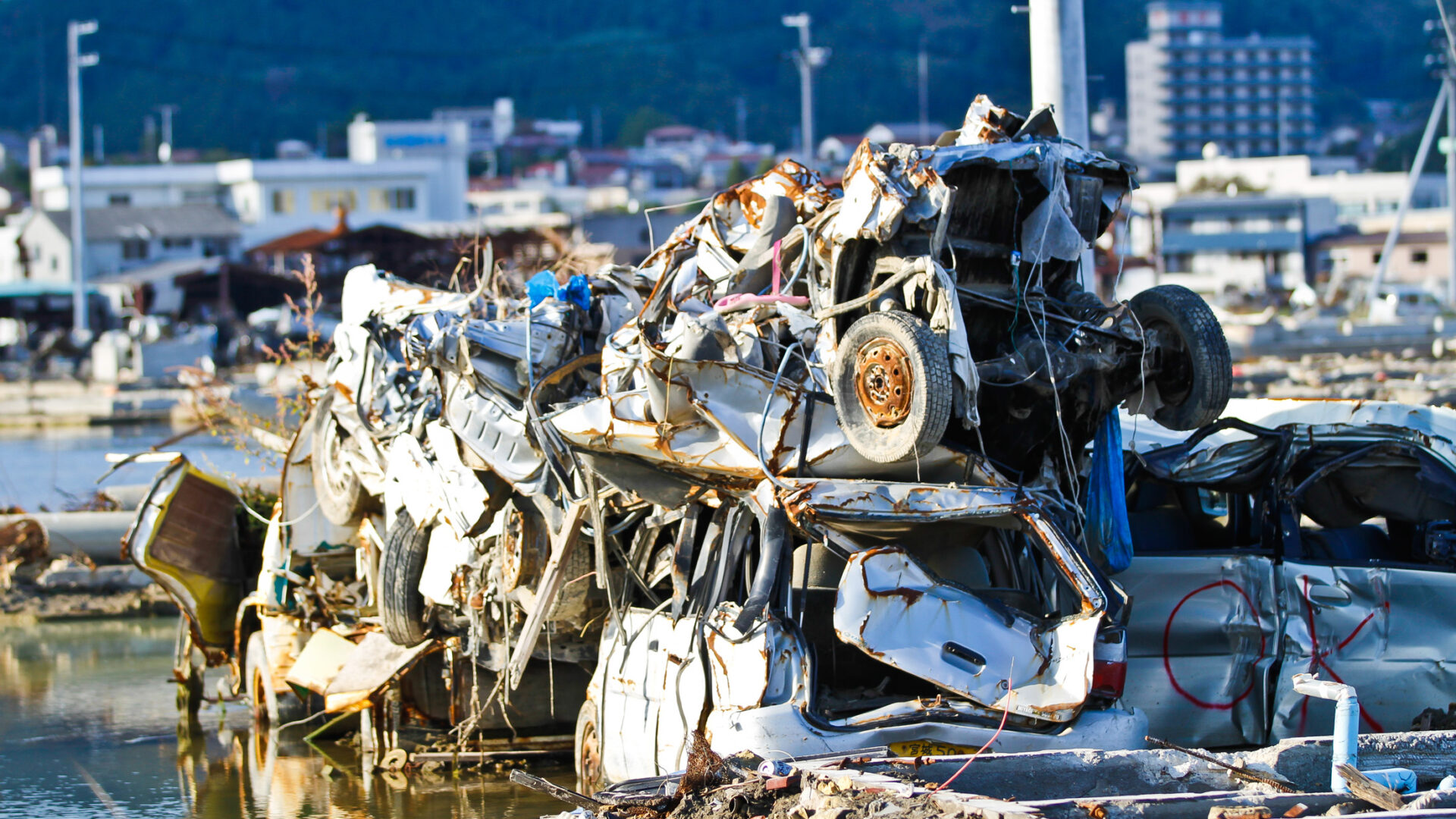 Devastation in Iwate: aftermath of natural disaster in Japan, vehicles piled up on waterfront.