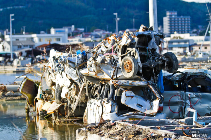 Devastation in Iwate: aftermath of natural disaster in Japan, vehicles piled up on waterfront.