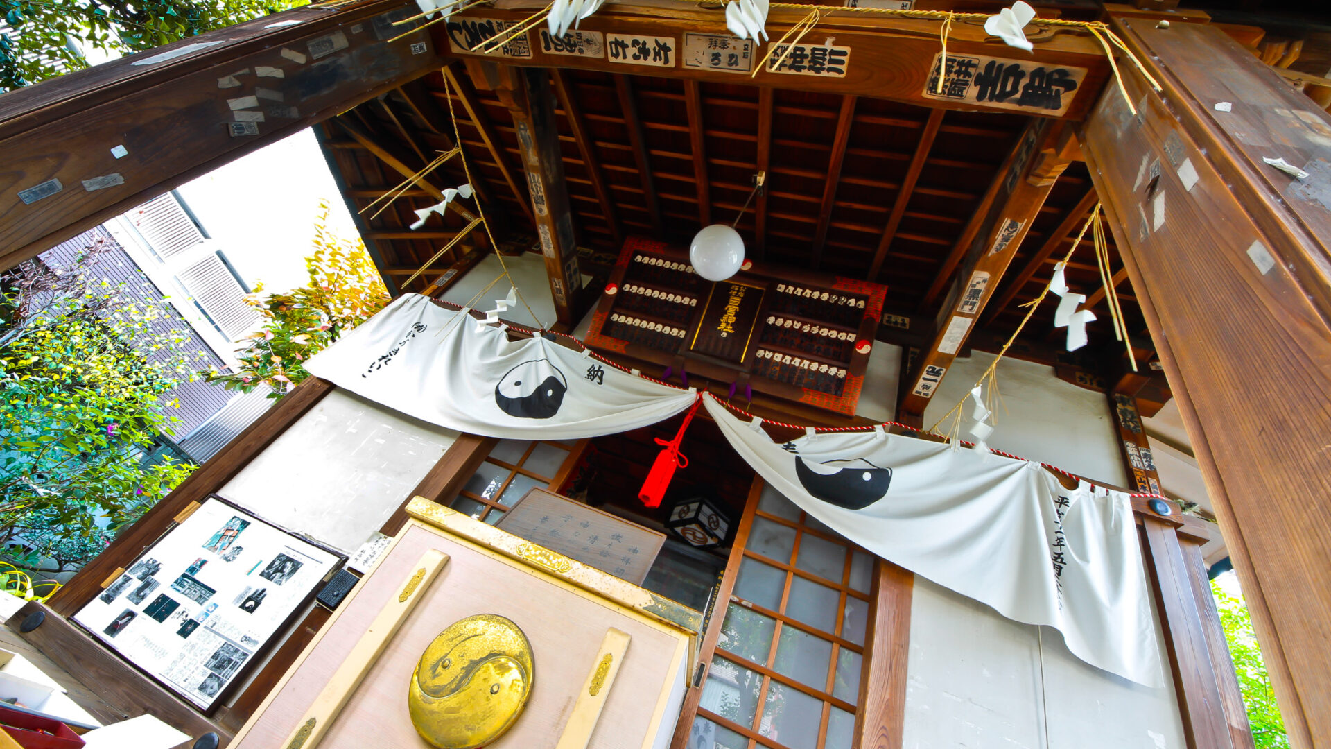 Traditional Japanese shrine interior with wooden beams, lanterns, and serene atmosphere in Tokyo.