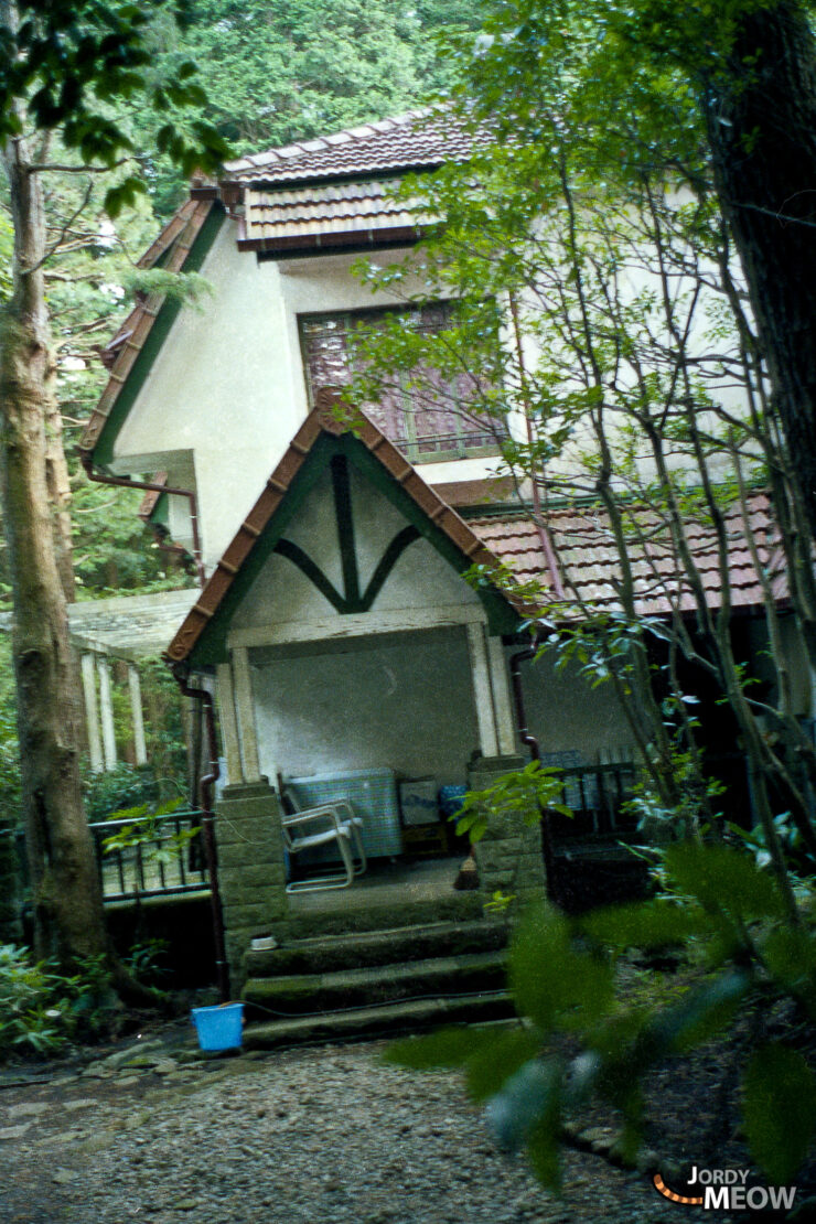 Forgotten Majesty: Abandoned Royal House in lush, overgrown forest of Kanto, Japan.