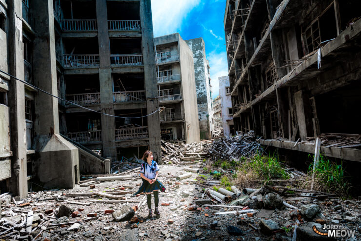 Exploring Gunkanjima: A lone explorer amidst haunting urban decay in Nagasaki, Japan.