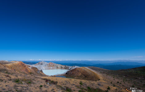 Majestic Mount Shirane: Volcanic beauty with emerald crater lake in Japan.