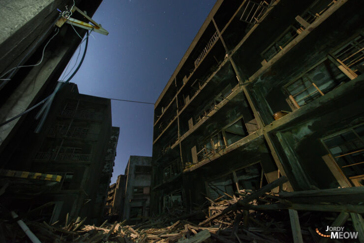 Exploring eerie abandoned streets of Gunkanjima at night.