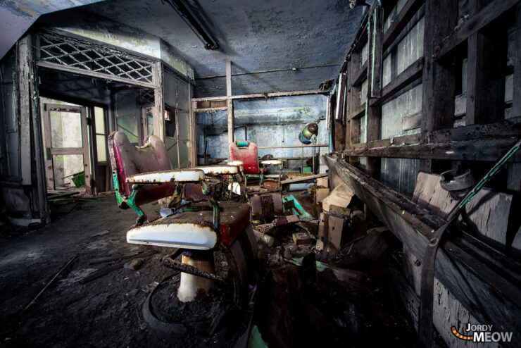 Explore haunting beauty of abandoned salon on Gunkanjima, Nagasaki, Japan; witness decayed interior and relics.