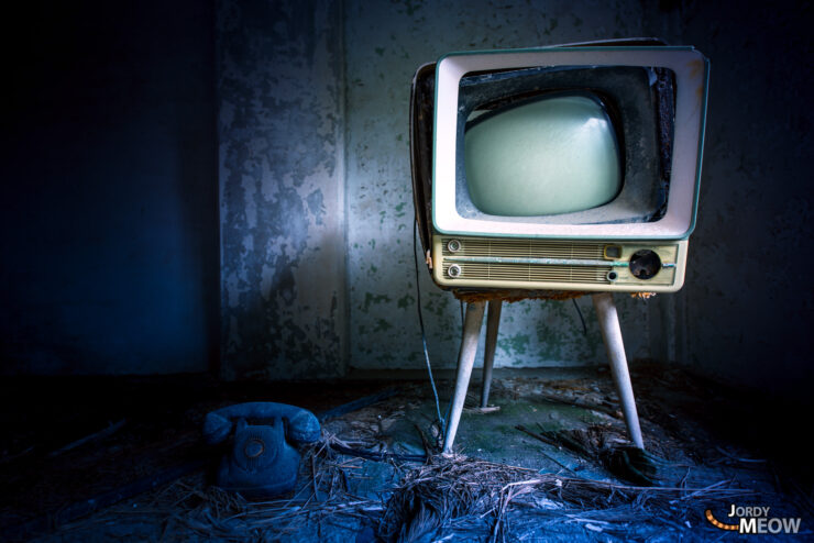 Lost television in Gunkanjima, Japan, capturing haunting beauty of abandoned urban landscape.