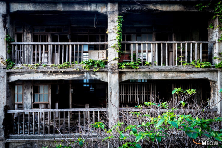 Gunkanjima: Abandoned island in Japan with decaying buildings reclaimed by nature.