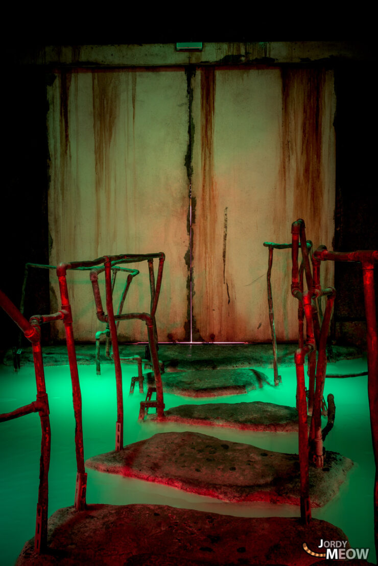 Eerie Japanese warehouse gaming center with worn chairs and haunting atmosphere.