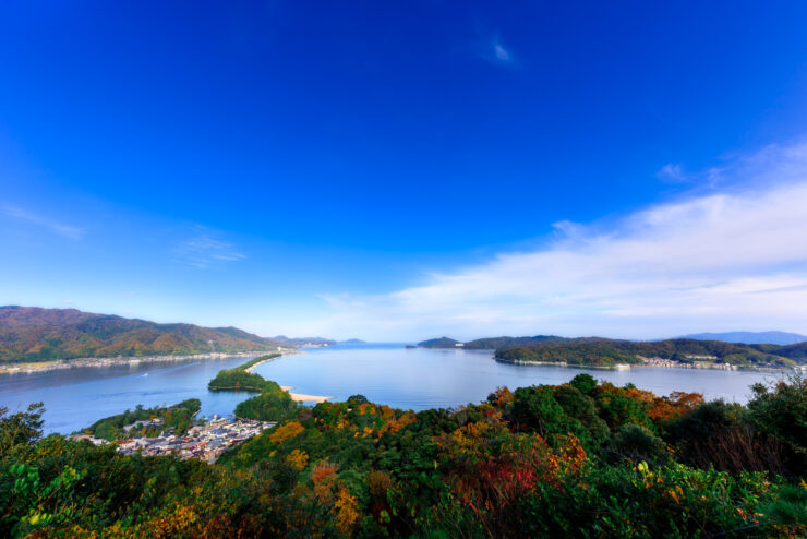 Awe-inspiring Amanohashidate sandbar with lush surroundings and majestic mountains in Japan.