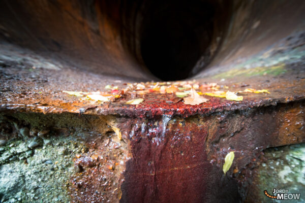 Abandoned hydro plant in Tohoku, Japan, surrounded by vibrant autumn colors.