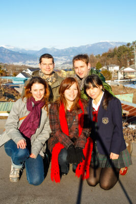 Friends enjoying Bessho Onsen hot spring resort with stunning mountain backdrop.