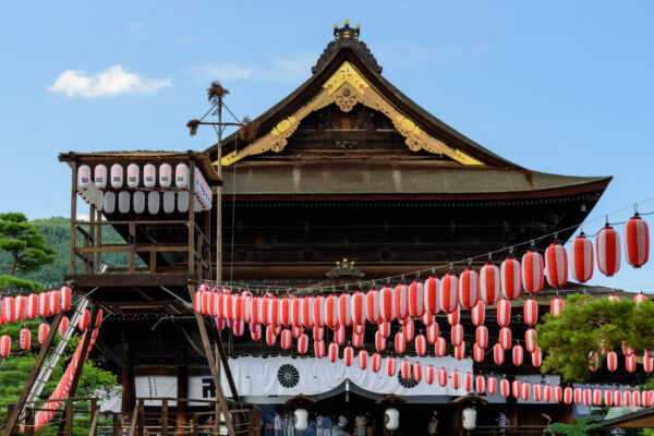 Zenkoji Temple in Nagano, Japan: iconic Buddhist site with intricate roof and vibrant lanterns.