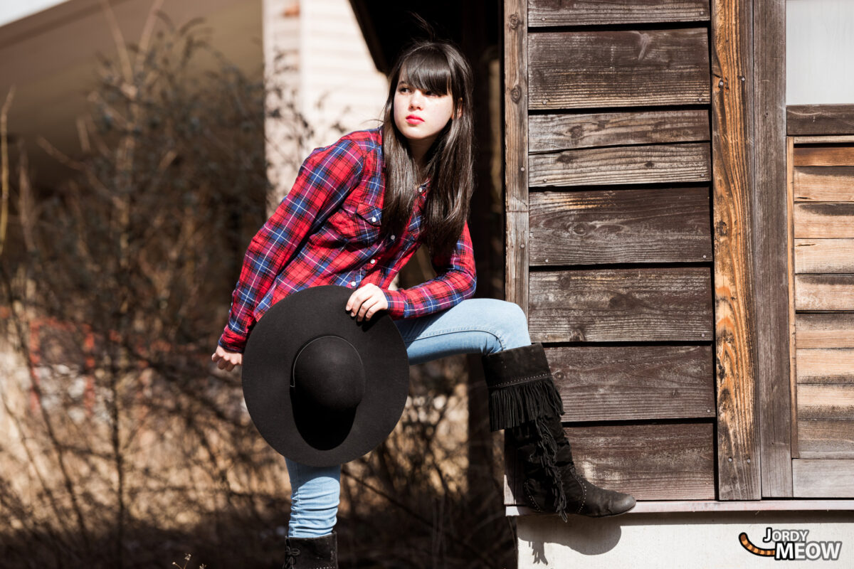 Explore abandoned Western Village in Japan with melancholic woman amidst fading theme park remnants.