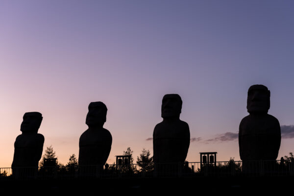 Enigmatic Moai statues silhouetted at sunset in Hokkaido, Japan.