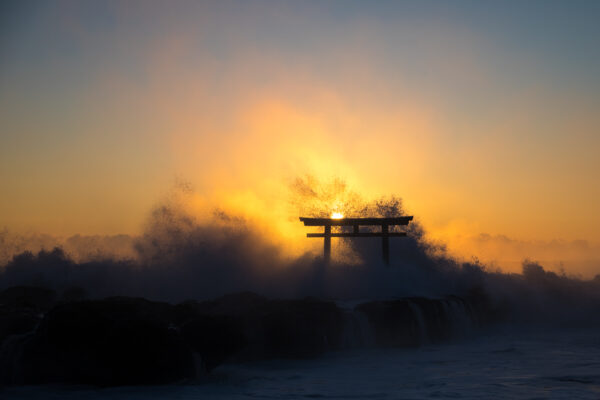 Tranquil sunset view of Oarai Isosaki Shrines iconic torii gate in Japan.