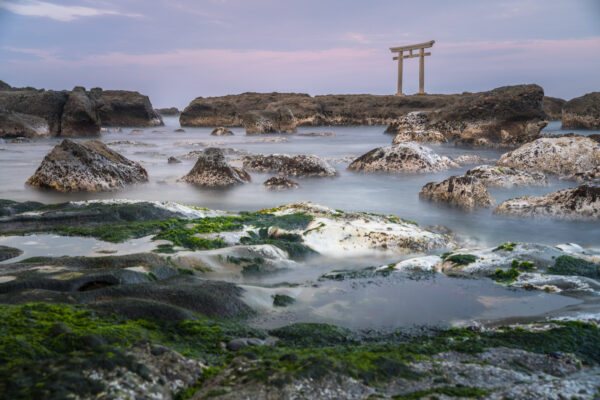 Enchanting Oarai Isosaki Shrine in Japan by the tranquil waters and moss-covered rocks.