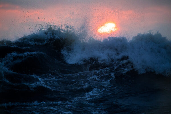 Sunset waves crashing dramatically at Oarai Isosaki Shrine, showcasing natures raw power.