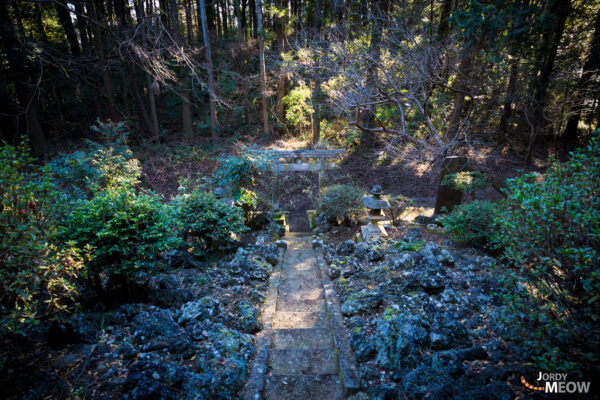 Oarai Isosaki Shrine: Spiritual Icon on Rocky Coastline in Japan, bathed in golden light.