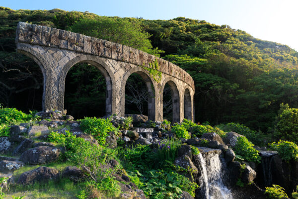 Enchanting Aqueduct Oasis with Greek-inspired Koga stone sculptures and harmonious water features.