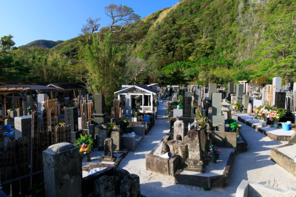 Tranquil Nichiren Sect Cemetery at Choei-ji Temple with unique tombstones, sake barrel, and dice.