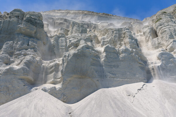 Niijimas Spectacular White Cliffs: Unique rhyolite formations standing tall against blue sky.