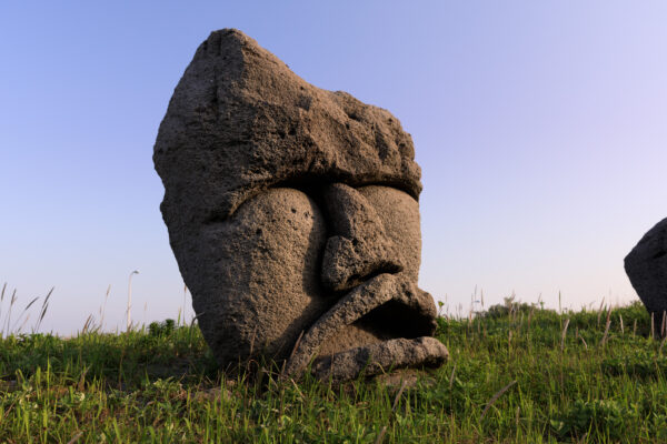 Niijima Stone Head Sculpture in natural setting on Niijima Island.