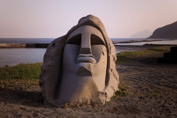 Sculptures in Niijima Bay, Japan: weathered stone with minimalist design and contemplative expression.