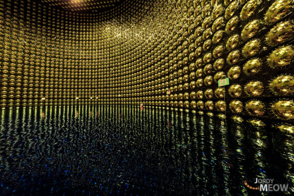 Golden spheres in Super-Kamiokande neutrino observatory, showcasing scientific precision and artistic beauty.