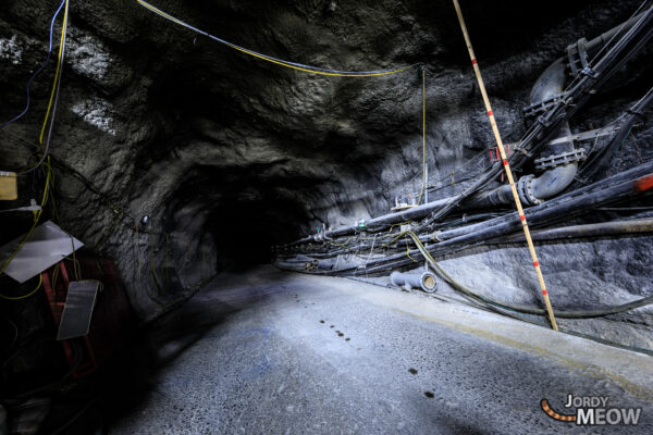 Exploring Neutrinos: Super-Kamiokande Observatory in underground space with scientific equipment and spotlights.