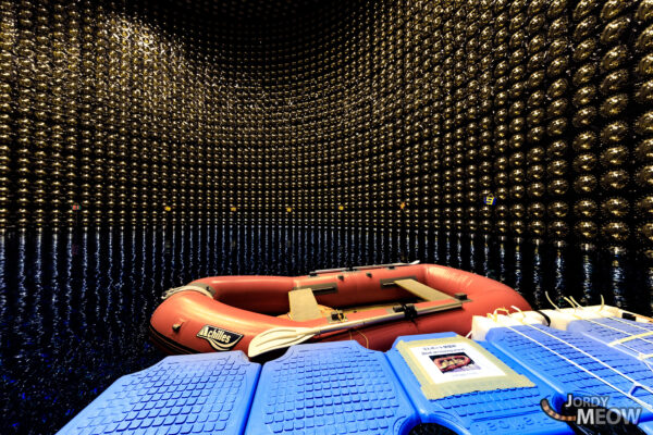 Super-Kamiokande: Neutrino observatory interior with golden photomultiplier tubes and blue panels.