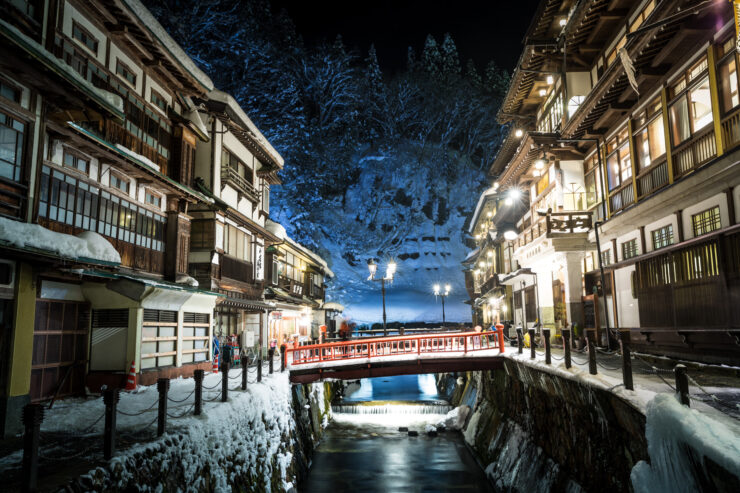 Enchanting winter scene of Ginzan Onsen in Japanese Alps - serene and magical ambiance.