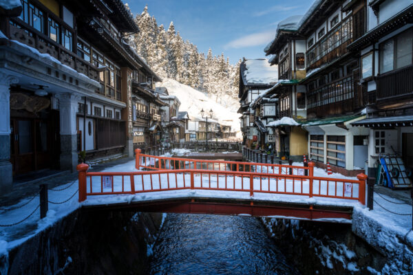 Explore Japans Ginzan Onsen: a charming winter village with traditional architecture and hot springs.