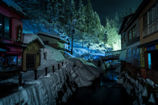 Enchanting winter scene of Ginzan Onsen, a traditional hot spring resort in Japan.