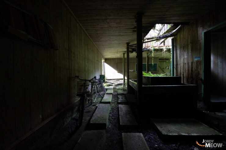 Eerie abandoned Kyushu schoolhouse hallway.