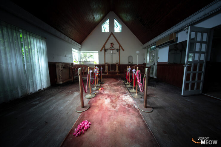 Desolate wedding chapel in Japan evoking neglect and melancholy, abandoned and decaying.