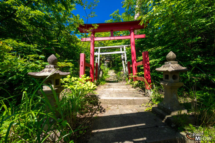 Beautiful abandoned Shinto shrine on Sado Island, Japan, nestled amidst lush greenery.