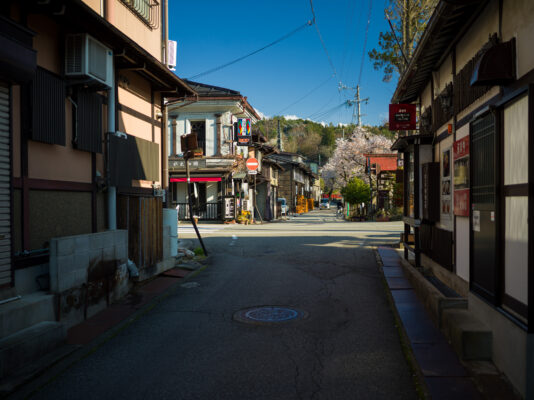 Exploring Takayamas Historic Charm: Traditional wooden buildings, cherry blossom trees, rich cultural heritage.