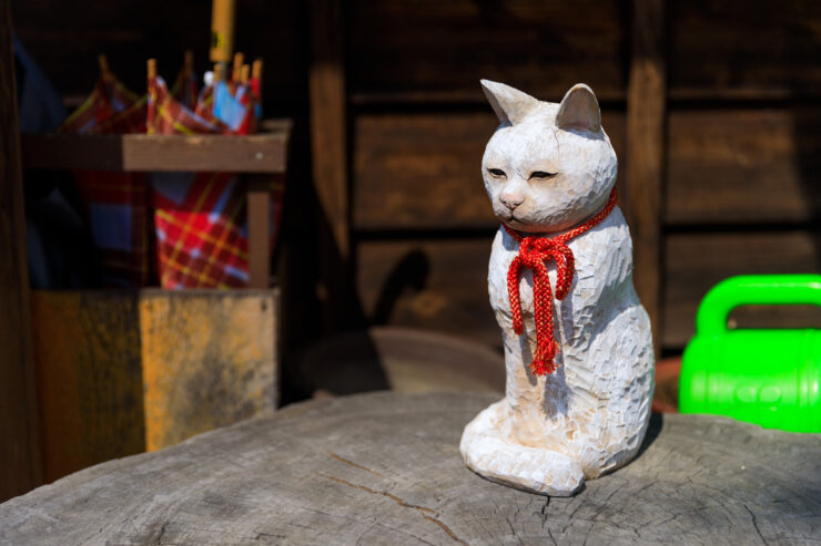 Whimsical Japanese Alley with Scarved Cat Statue