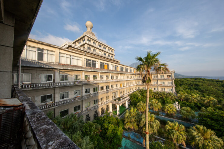 Luxurious Hachijo Royal Hotel amidst lush palm trees in Japan.