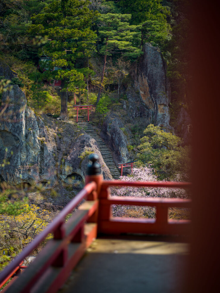 Serene red bridge to Natadera Temple in mountain scenery