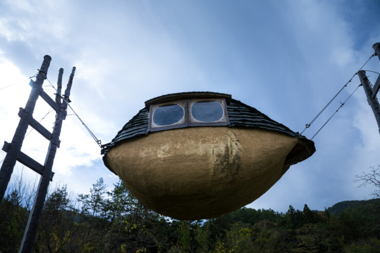 Whimsical Earthen Aircraft Levitating Above Forest