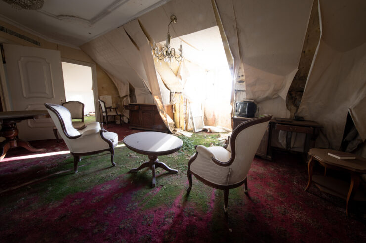 Abandoned Gluck Theme Park - Faded grandeur of opulent interior in neglected state.