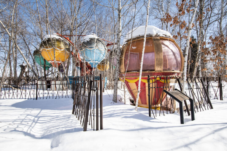 Whimsical winter scene with colorful domes in snowy landscape at Gluck Kingdom.