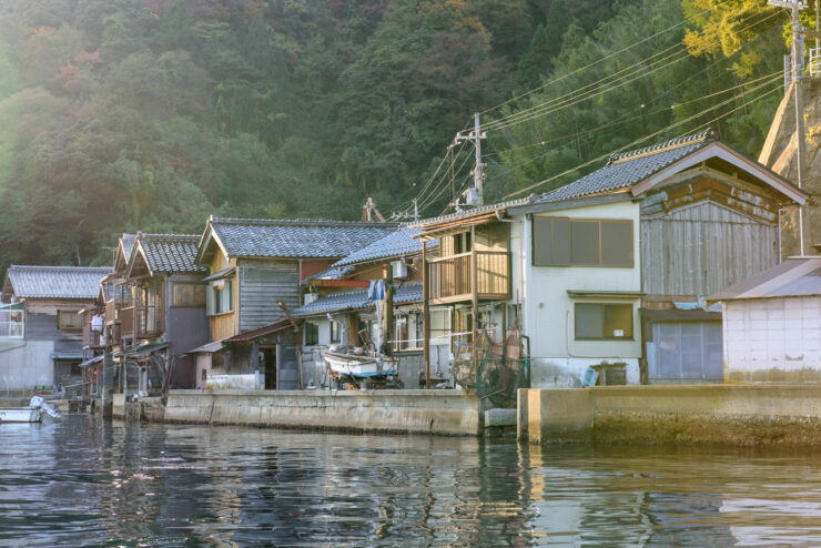 Charming boat houses along the serene waterfront of Ine, Japan.
