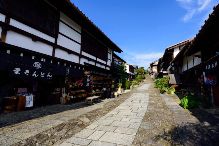 Explore historic charm in Magome-Juku village, showcasing traditional Japanese architecture and lush greenery.