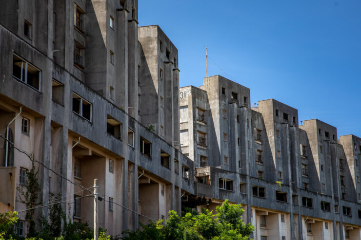 Eerie abandoned concrete island housing decay.