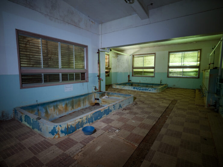 Abandoned indoor pool, eerie forgotten recreational space.