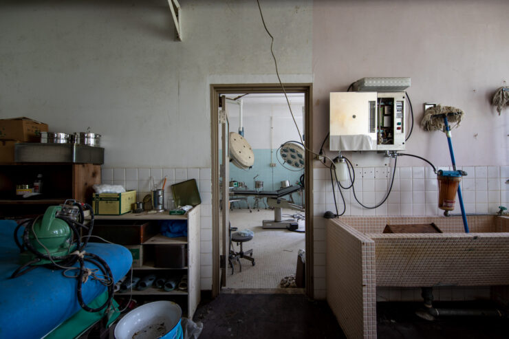 Neglected medical room at abandoned Ikeshima mine facility.
